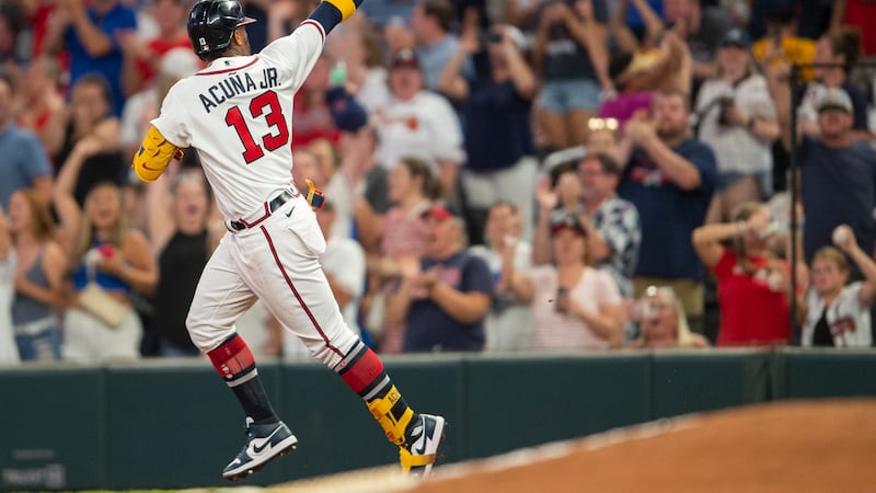 Atlanta Braves Ronald Acuna Jr. gestures after hitting a solo home run in the fifth inning of...