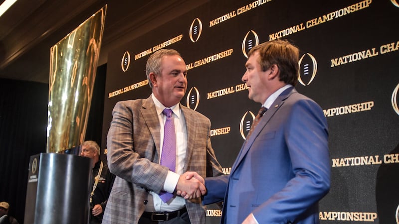 TCU head coach Sonny Dykes, left, speaks with Georgia head coach Kirby Smart after a news...