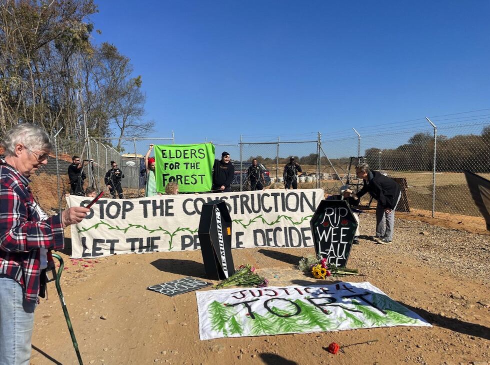 About two dozen protesters sat outside the future site of the Public Safety Training Center on...