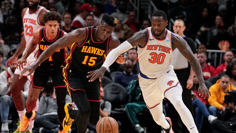Atlanta Hawks center Clint Capela (15) and New York Knicks forward Julius Randle (30) both...