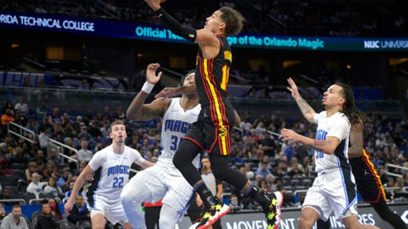 Atlanta Hawks guard Trae Young (11) goes up for a shot in front of Orlando Magic forward Franz...