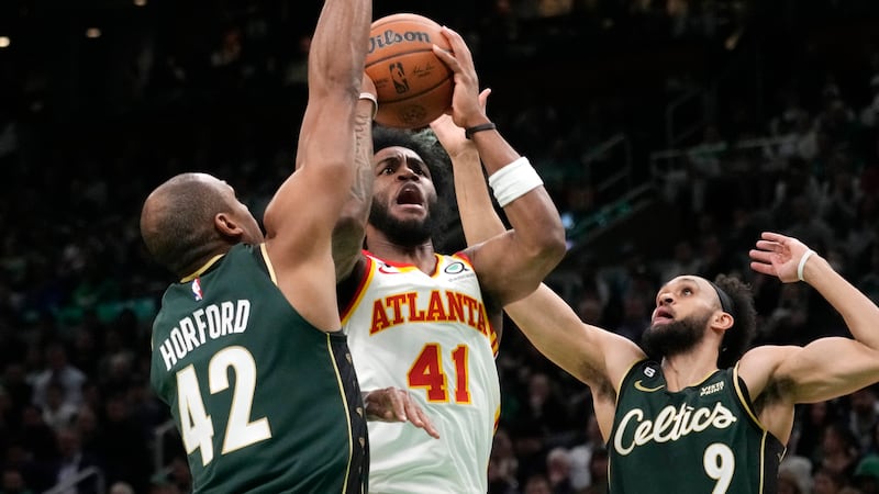 Atlanta Hawks forward Saddiq Bey (41) is pressured on his shot by Boston Celtics center Al...