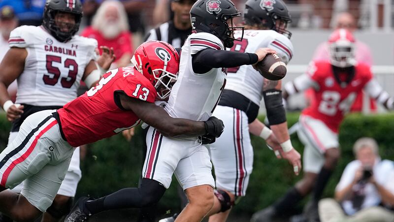 South Carolina quarterback Spencer Rattler (7) is hit by Georgia defensive lineman Mykel...