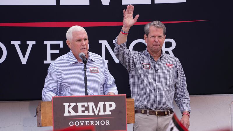 Republican Gov. Brian Kemp, right, reacts as former Vice President Mike Pence speaks during a...