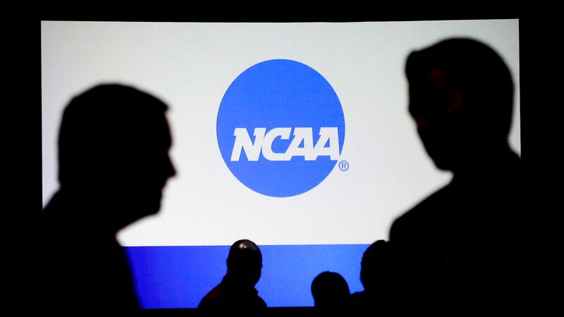 People talk after a panel discussion at the NCAA Convention Thursday, Jan. 19, 2017, in...
