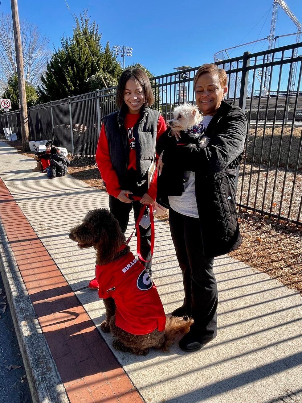 Bulldogs fans and their dogs in championship gear