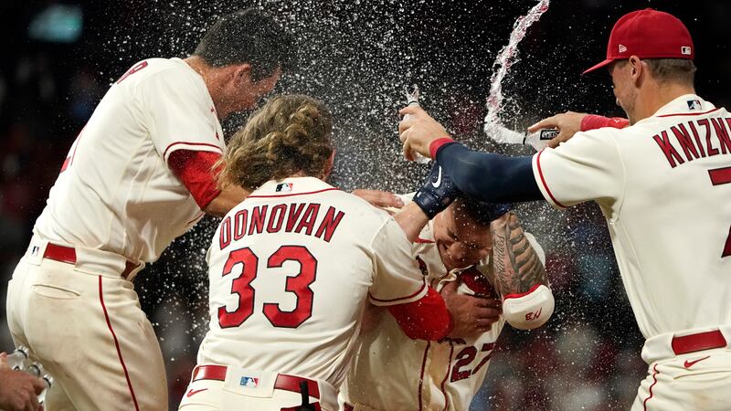 St. Louis Cardinals' Tyler O'Neill (27) is congratulated by teammates Lars Nootbaar, left,...