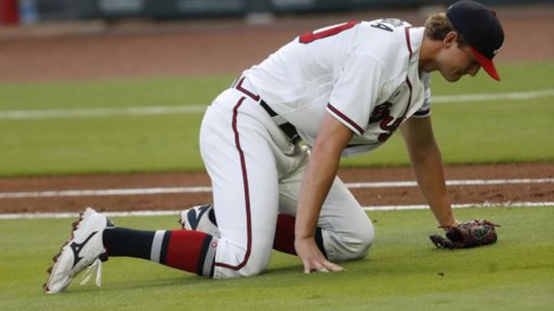 Atlanta Braves starting pitcher Mike Soroka (40) waits for assistance from the training staff...
