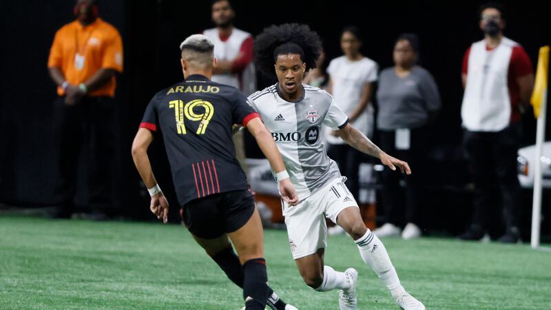 Atlanta United's Luiz Araújo (19) and Toronto FC's Jayden Nelson (11) go for the ball in the...