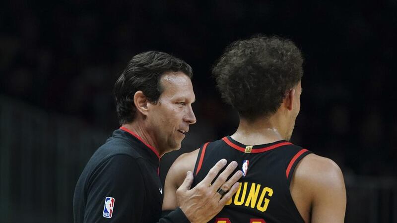 Newly hired Atlanta Hawks teach coach Quin Snyder talks with guard Trae Young (11) during the...