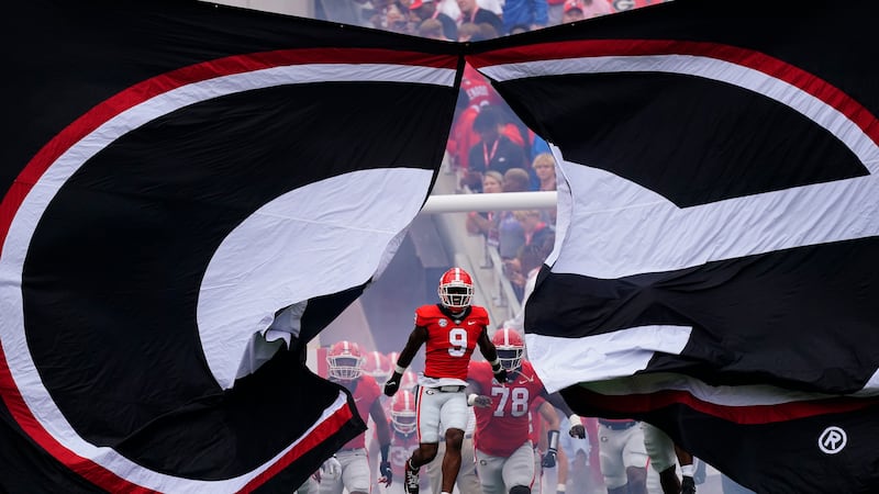 Georgia's Jackson Meeks (9) leads the Bulldogs onto the field for an NCAA college football...