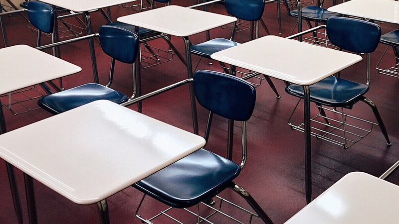 File - Empty desks in a classroom.