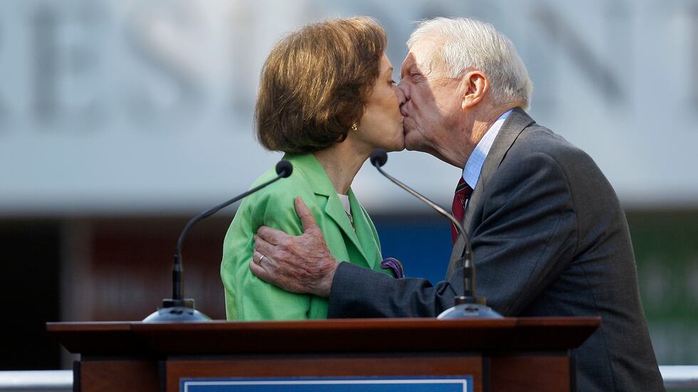 FILE - This Oct. 1, 2009 file photo shows former President Jimmy Carter getting a kiss from...