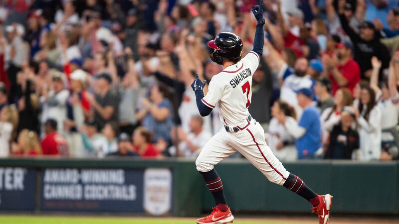 Atlanta Braves' Dansby Swanson reacts after hitting a solo home run in the first inning of a...
