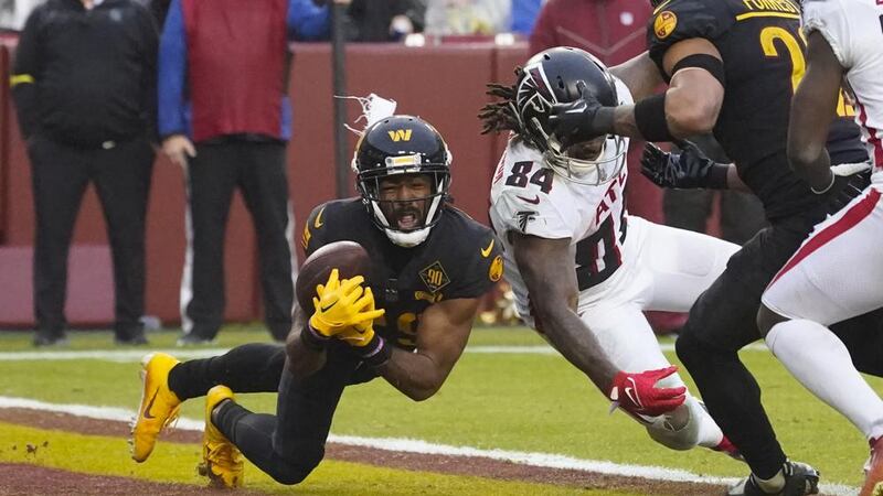 Washington Commanders cornerback Kendall Fuller (29) makes an interception against Atlanta...