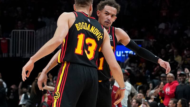 Atlanta Hawks guards Trae Young and Bogdan Bogdanovic (13) celebrate after a Hawks basket...