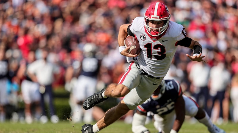 FILE - Georgia quarterback Stetson Bennett (13) carries the ball against Auburn during the...