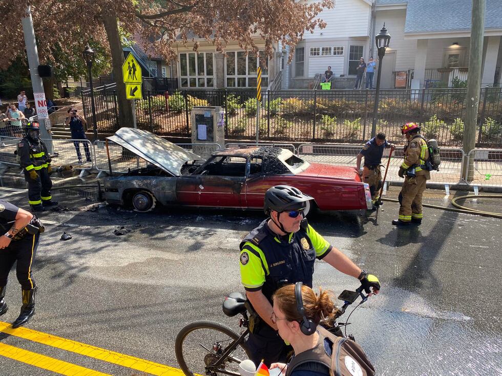 Emergency crews extinguish car fire.