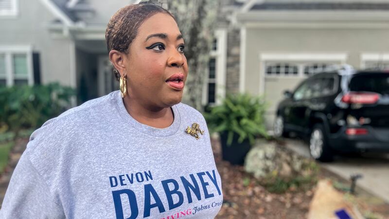 Devon Dabney, a candidate for city council in Johns Creek, Ga., stands outside her home and...