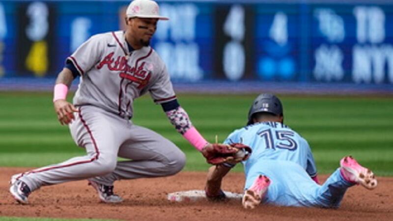 Toronto Blue Jays' Whit Merrifield (15) steals second base past a tag by Atlanta Braves...